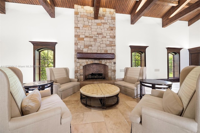 10101 SW 60th Ct, Pinecrest, FL 33156 - living area featuring a wood ceiling with exposed beams, a towering ceiling, and a stone fireplace