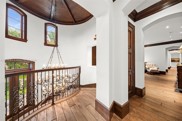 10101 SW 60th Ct, Pinecrest, FL 33156 - corridor featuring arched walkways, hardwood / wood-style flooring, a chandelier, ornamental molding, and recessed lighting