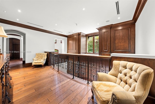 10101 SW 60th Ct, Pinecrest, FL 33156 - sitting room featuring light wood finished floors, arched walkways, recessed lighting, and crown molding