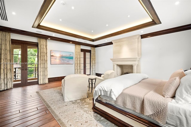 10101 SW 60th Ct, Pinecrest, FL 33156 - bedroom with french doors, hardwood / wood-style floors, a tray ceiling, access to exterior, and crown molding