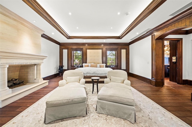 10101 SW 60th Ct, Pinecrest, FL 33156 - bedroom featuring hardwood / wood-style floors, a tray ceiling, crown molding, and a premium fireplace