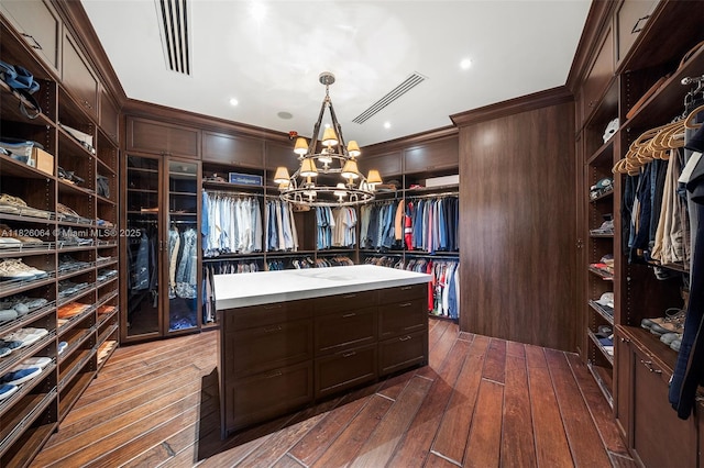 10101 SW 60th Ct, Pinecrest, FL 33156 - walk in closet with a chandelier and dark wood-type flooring