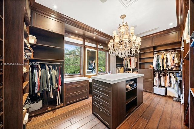 10101 SW 60th Ct, Pinecrest, FL 33156 - spacious closet with a chandelier and hardwood / wood-style floors