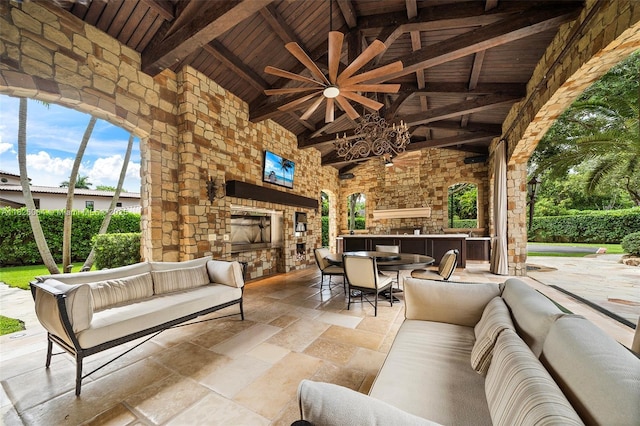 10101 SW 60th Ct, Pinecrest, FL 33156 - view of patio featuring an outdoor living space with a fireplace, exterior kitchen, a ceiling fan, and outdoor dining space