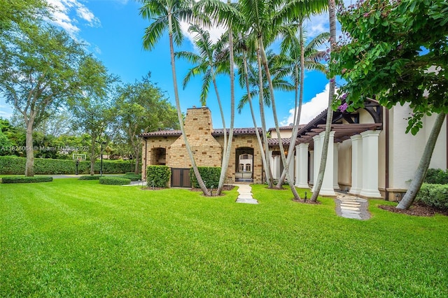 10101 SW 60th Ct, Pinecrest, FL 33156 - back of property featuring stucco siding, a lawn, and a tile roof