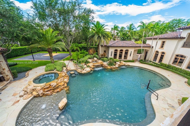10101 SW 60th Ct, Pinecrest, FL 33156 - swimming pool with an in-ground hot tub and a patio area