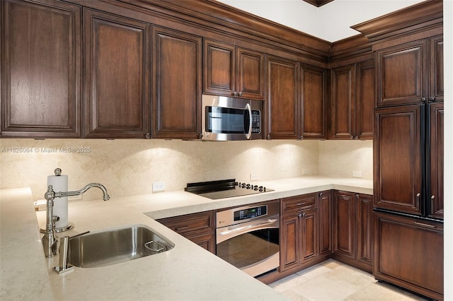 10101 SW 60th Ct, Pinecrest, FL 33156 - kitchen featuring appliances with stainless steel finishes, light countertops, backsplash, and dark brown cabinets