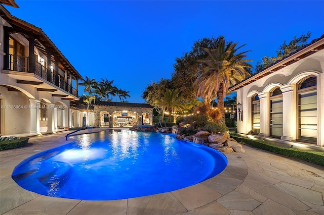 10101 SW 60th Ct, Pinecrest, FL 33156 - pool at twilight with a patio and a pool with connected hot tub