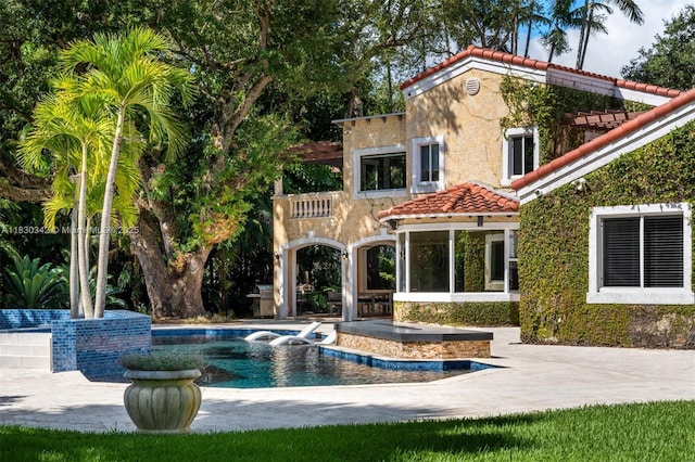 11401 SW 69th Ave, Pinecrest, FL 33156 - back of house with a tiled roof, an outdoor pool, a patio area, and stucco siding