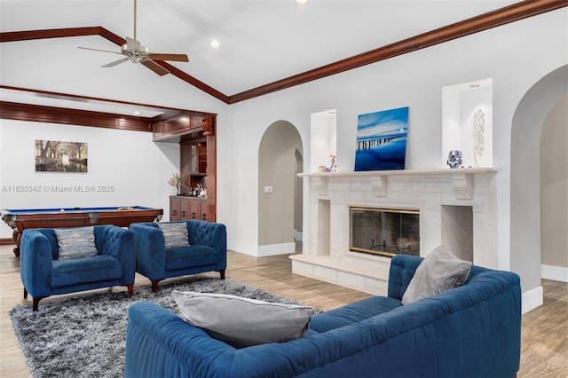 11401 SW 69th Ave, Pinecrest, FL 33156 - living area featuring arched walkways, ornamental molding, billiards table, wood finished floors, and a glass covered fireplace