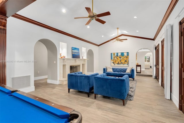 11401 SW 69th Ave, Pinecrest, FL 33156 - living room featuring arched walkways, a ceiling fan, light wood-style floors, a glass covered fireplace, and lofted ceiling