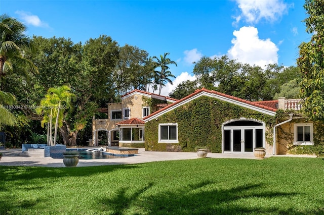 11401 SW 69th Ave, Pinecrest, FL 33156 - rear view of house featuring french doors, a lawn, an outdoor pool, and a patio