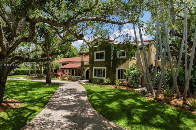 11401 SW 69th Ave, Pinecrest, FL 33156 - mediterranean / spanish-style home with a front lawn, covered porch, and stucco siding