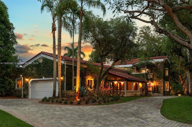 11401 SW 69th Ave, Pinecrest, FL 33156 - view of front facade with a tile roof, decorative driveway, and an attached garage