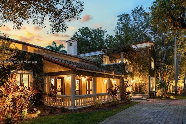11401 SW 69th Ave, Pinecrest, FL 33156 - rear view of house with a chimney, a tiled roof, and a porch