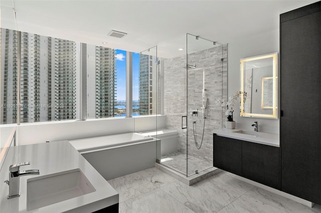 851 NE 1st Ave Unit 3201, Miami, FL 33132 - full bathroom with vanity, a shower stall, marble finish floors, and a bathtub