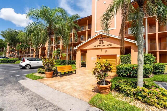 701 SW 141st Ave Unit 406R, Pembroke Pines, FL 33027 - view of property featuring uncovered parking