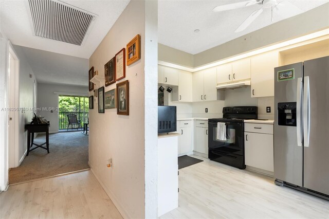 701 SW 141st Ave Unit 406R, Pembroke Pines, FL 33027 - kitchen with stainless steel fridge, black range with electric cooktop, under cabinet range hood, light countertops, and light wood-style flooring