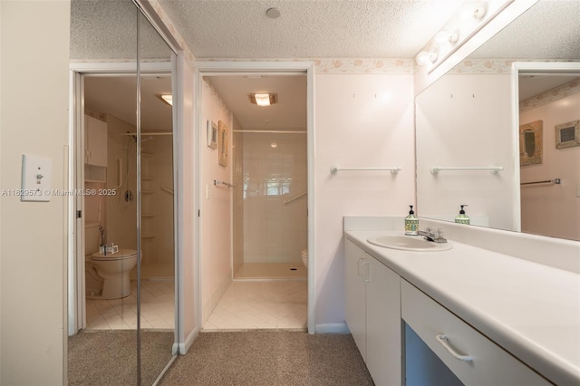 701 SW 141st Ave Unit 406R, Pembroke Pines, FL 33027 - full bath featuring a textured ceiling, vanity, tile patterned floors, and tiled shower