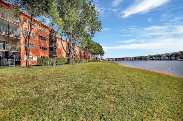 701 SW 141st Ave Unit 406R, Pembroke Pines, FL 33027 - view of community featuring a lawn and a water view