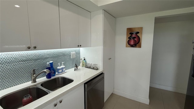 16546 NE 26th Ave Unit 4I, North Miami Beach, FL 33160 - kitchen featuring dishwasher, white cabinetry, light countertops, light tile patterned floors, and backsplash
