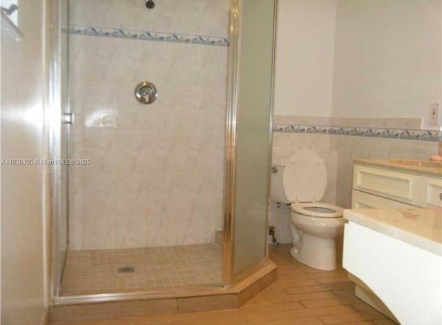 6790 SW 10th Ct, Pembroke Pines, FL 33023 - bathroom featuring vanity, a shower stall, wainscoting, and wood finished floors
