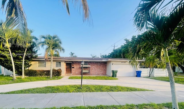 6790 SW 10th Ct, Pembroke Pines, FL 33023 - ranch-style home featuring curved driveway, a garage, stucco siding, and brick siding