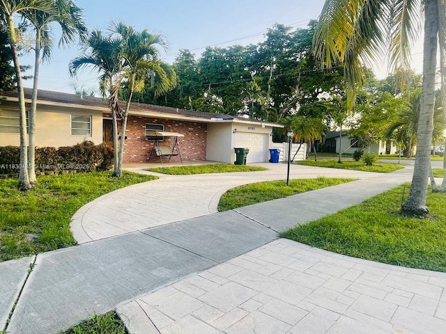 6790 SW 10th Ct, Pembroke Pines, FL 33023 - view of front facade with decorative driveway, a garage, stucco siding, and a front yard