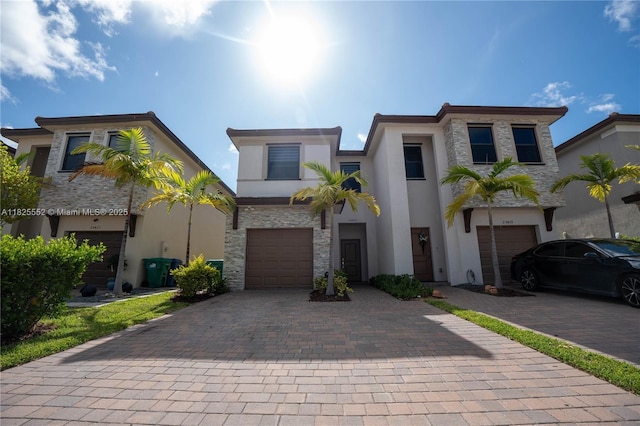 25433 SW 108th Ct, Homestead, FL 33032 - view of front facade with an attached garage, decorative driveway, stucco siding, and stone siding