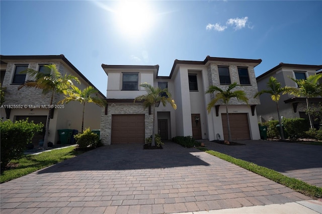 25433 SW 108th Ct, Homestead, FL 33032 - modern home featuring decorative driveway, stucco siding, and a garage