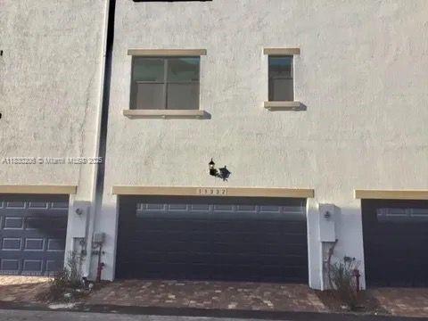 11332 SW 15th St, Pembroke Pines, FL 33025 - back of house with stucco siding and a garage