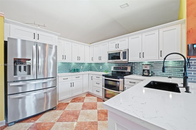 450 NW 195th Ave, Pembroke Pines, FL 33029 - kitchen with appliances with stainless steel finishes, tasteful backsplash, white cabinets, and light stone counters