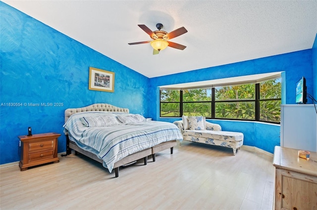 450 NW 195th Ave, Pembroke Pines, FL 33029 - bedroom featuring wood finished floors, vaulted ceiling, a ceiling fan, and a textured ceiling