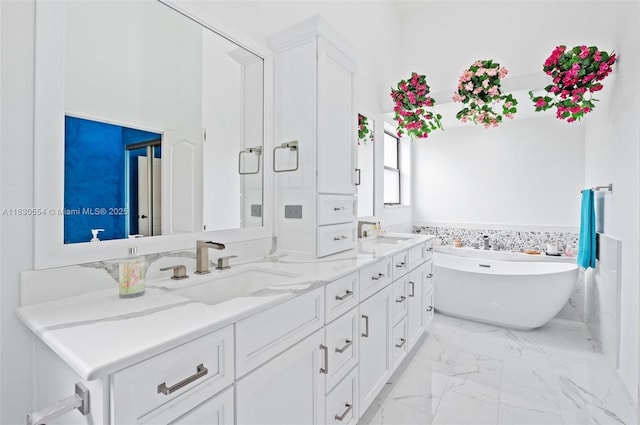 450 NW 195th Ave, Pembroke Pines, FL 33029 - full bath with double vanity, a freestanding bath, marble finish flooring, and wainscoting