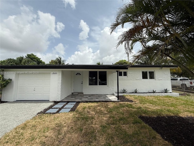 6201 SW 20th Ct, Miramar, FL 33023 - ranch-style house with an attached garage, driveway, and brick siding