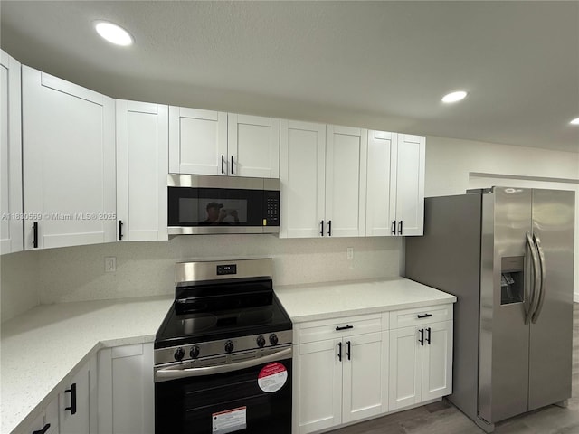 6201 SW 20th Ct, Miramar, FL 33023 - kitchen featuring appliances with stainless steel finishes, white cabinets, recessed lighting, and light stone countertops