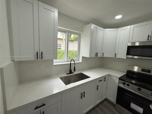 6201 SW 20th Ct, Miramar, FL 33023 - kitchen with appliances with stainless steel finishes, white cabinetry, recessed lighting, and dark wood-style floors