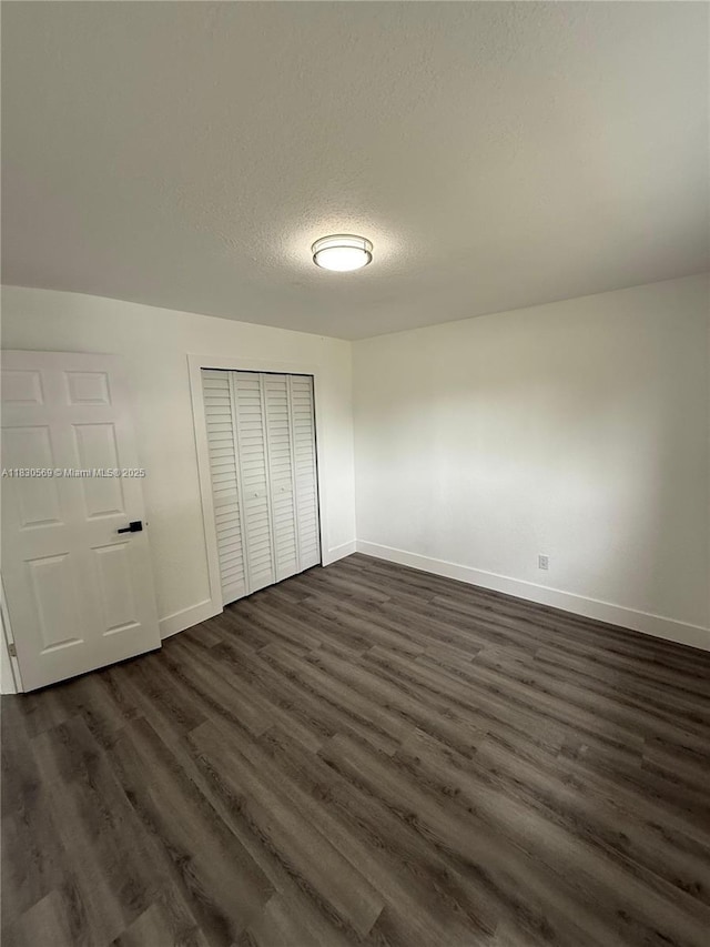 6201 SW 20th Ct, Miramar, FL 33023 - unfurnished bedroom featuring dark wood finished floors, a closet, and a textured ceiling