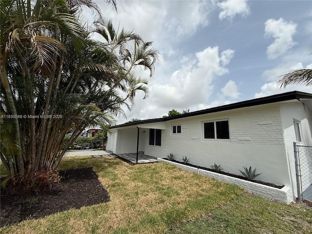 6201 SW 20th Ct, Miramar, FL 33023 - rear view of house featuring a yard, stucco siding, a patio, and a garage