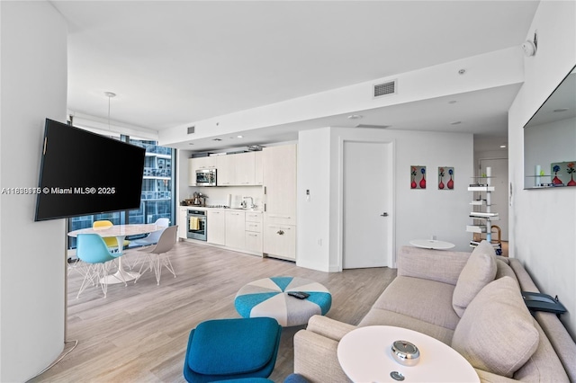 55 SW 9th St Unit 1801, Miami, FL 33130 - living area featuring bar with sink and light wood-type flooring