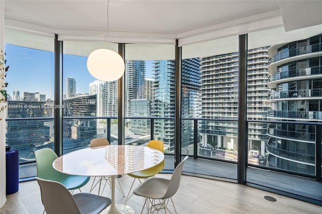 55 SW 9th St Unit 1801, Miami, FL 33130 - dining room featuring floor to ceiling windows, a skyline view, and wood finished floors