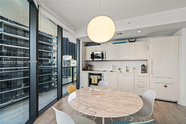 55 SW 9th St Unit 1801, Miami, FL 33130 - dining room featuring light wood-style floors and recessed lighting