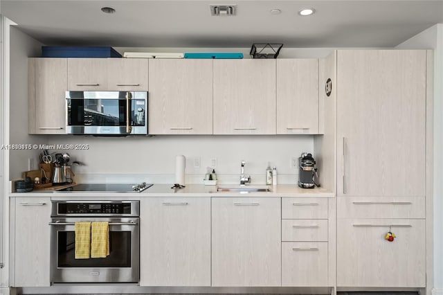 55 SW 9th St Unit 1801, Miami, FL 33130 - kitchen with appliances with stainless steel finishes, light countertops, light brown cabinets, modern cabinets, and recessed lighting