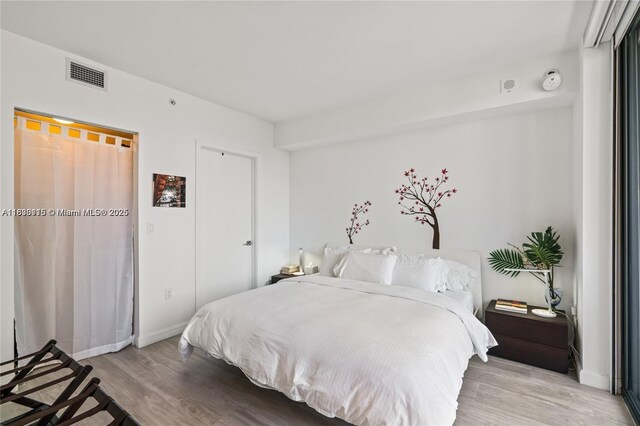55 SW 9th St Unit 1801, Miami, FL 33130 - bedroom with light wood finished floors and baseboards