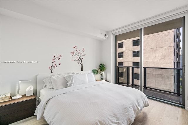 55 SW 9th St Unit 1801, Miami, FL 33130 - bedroom featuring wood finished floors and a wall of windows