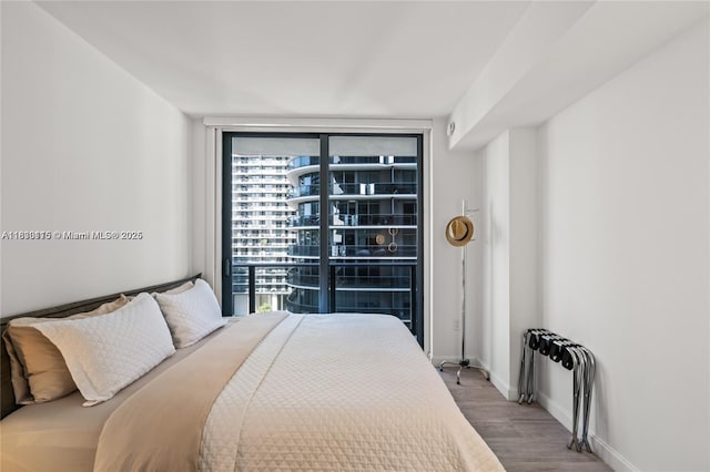 55 SW 9th St Unit 1801, Miami, FL 33130 - bedroom featuring wood finished floors and multiple windows
