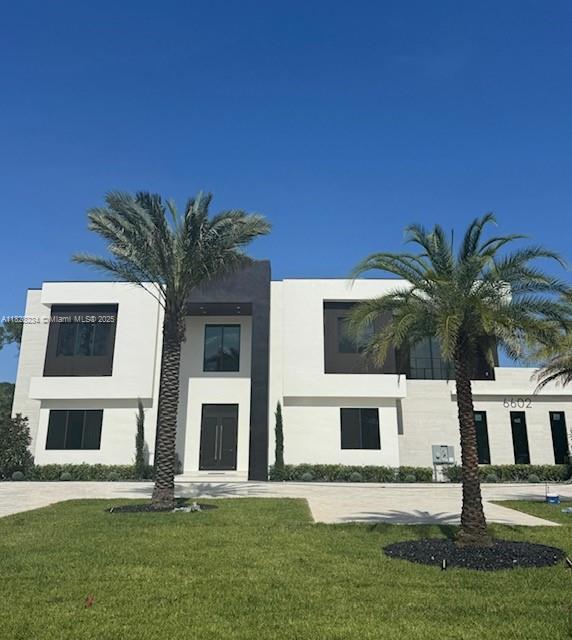 6602 NW 62th Ter, Parkland, FL 33067 - view of front facade with stucco siding and a front yard