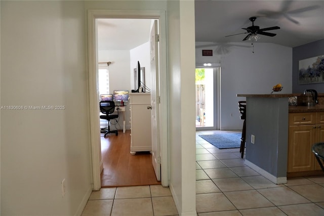 15132 SW 140th Ter, Miami, FL 33196 - hallway featuring light tile patterned floors and vaulted ceiling