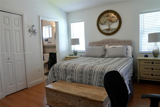 15132 SW 140th Ter, Miami, FL 33196 - bedroom featuring multiple windows, wood finished floors, a closet, and ensuite bath