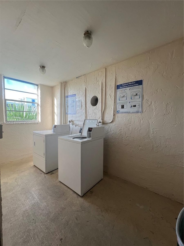 5050 NW 7th St Unit 709, Miami, FL 33126 - laundry area featuring washer and clothes dryer and a textured wall
